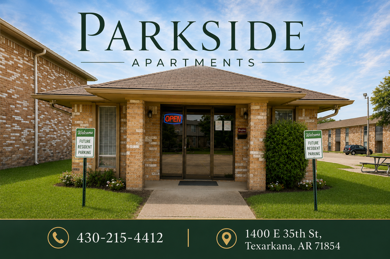 Parkside Apartments brick entrance with glass doors and signage, under a blue sky