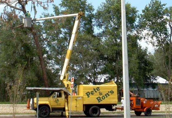 A yellow truck that says pete and ron 's on it