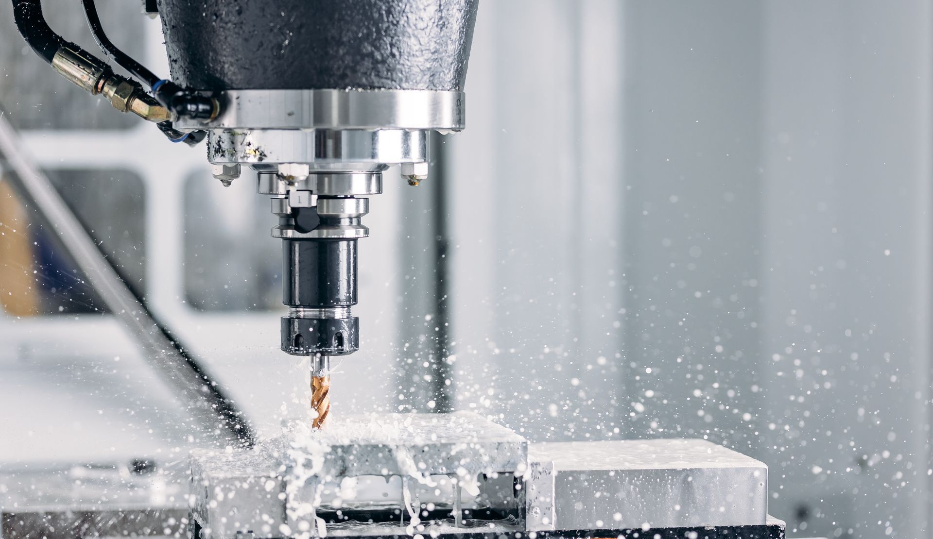 A machine is cutting a piece of metal in a factory.
