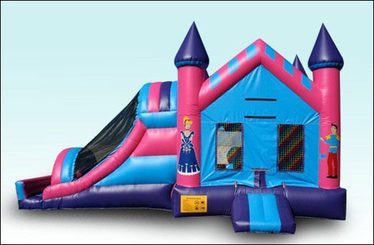 Pink and blue inflatable bounce house with slide and castle towers on a white background