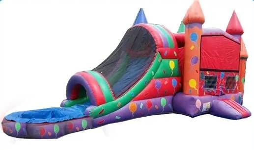 Colorful inflatable bounce house with slide, rainbow arch, and castle turrets