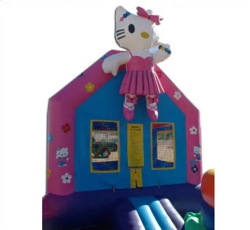 Pink house-shaped display with a Hello Kitty figure on top and small windows on the front.