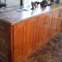 Wooden kitchen island with granite countertop and decorative horse figurines
