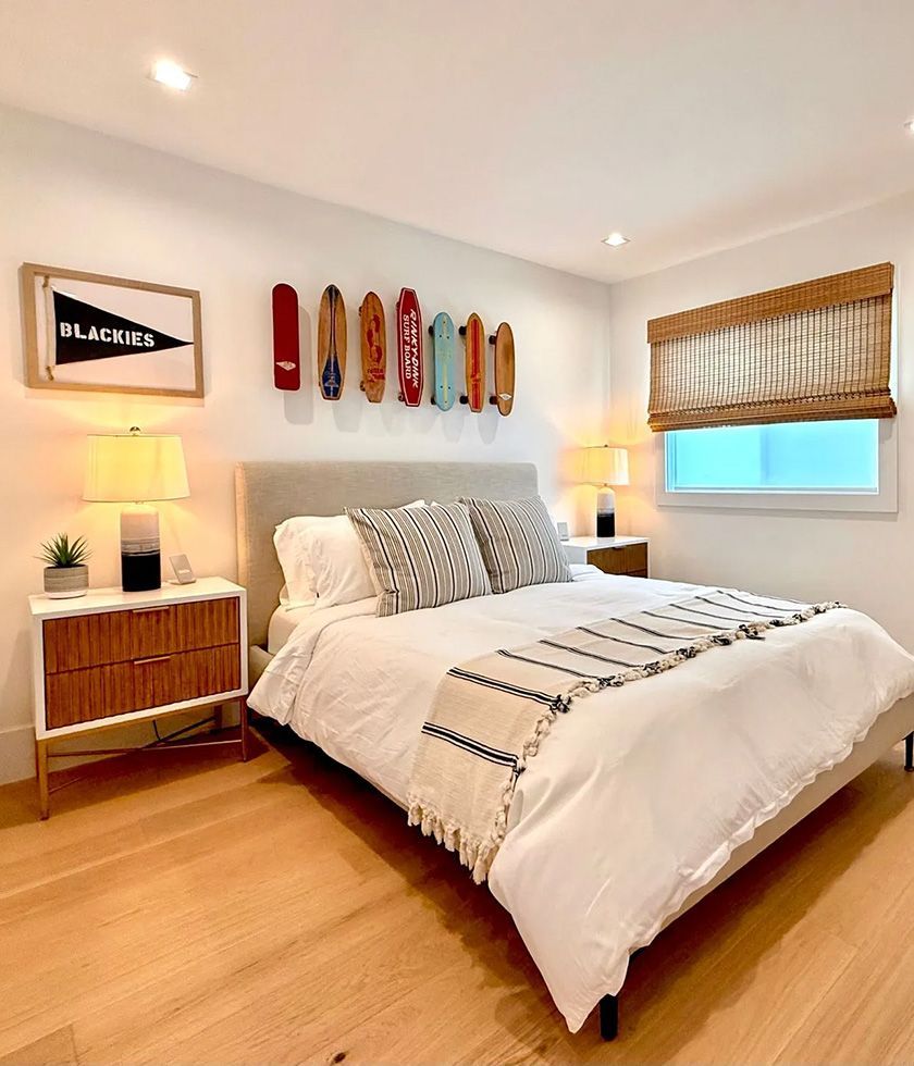 Harbor Lookout bedroom with queen bed and vintage skateboards on the wall