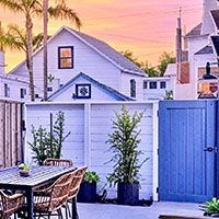 Surf Casita fire-pit patio at sunset with string lights