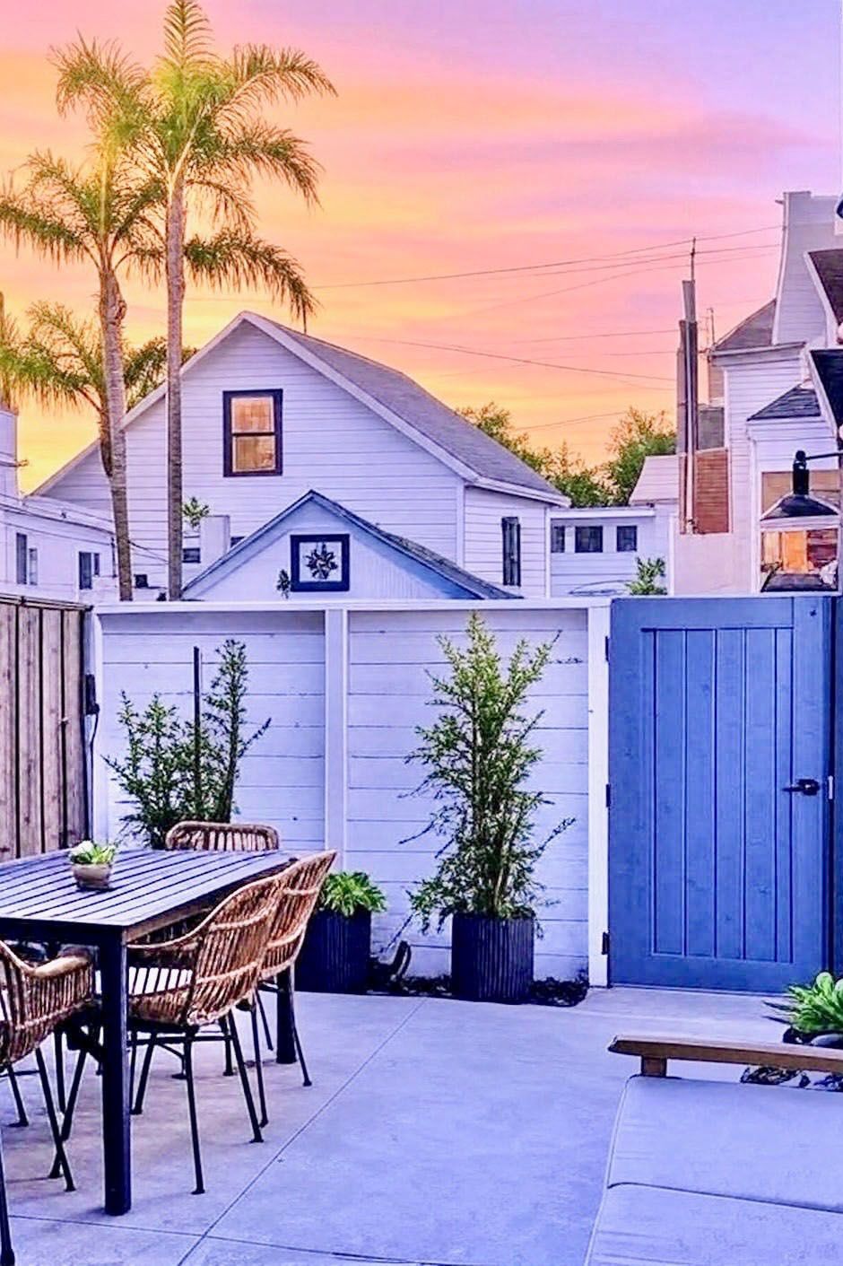 Surf Casita private patio with dining table and blue gate at sunset
