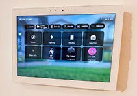 Wall-mounted smart-home touch panel controlling lighting, shades and music at Harbor Lookout