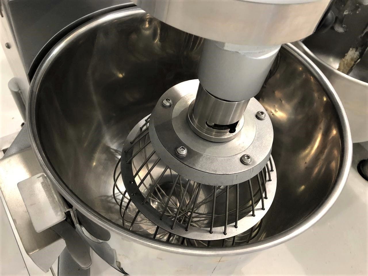 Um close de um mixer com uma tigela de aço inoxidável.