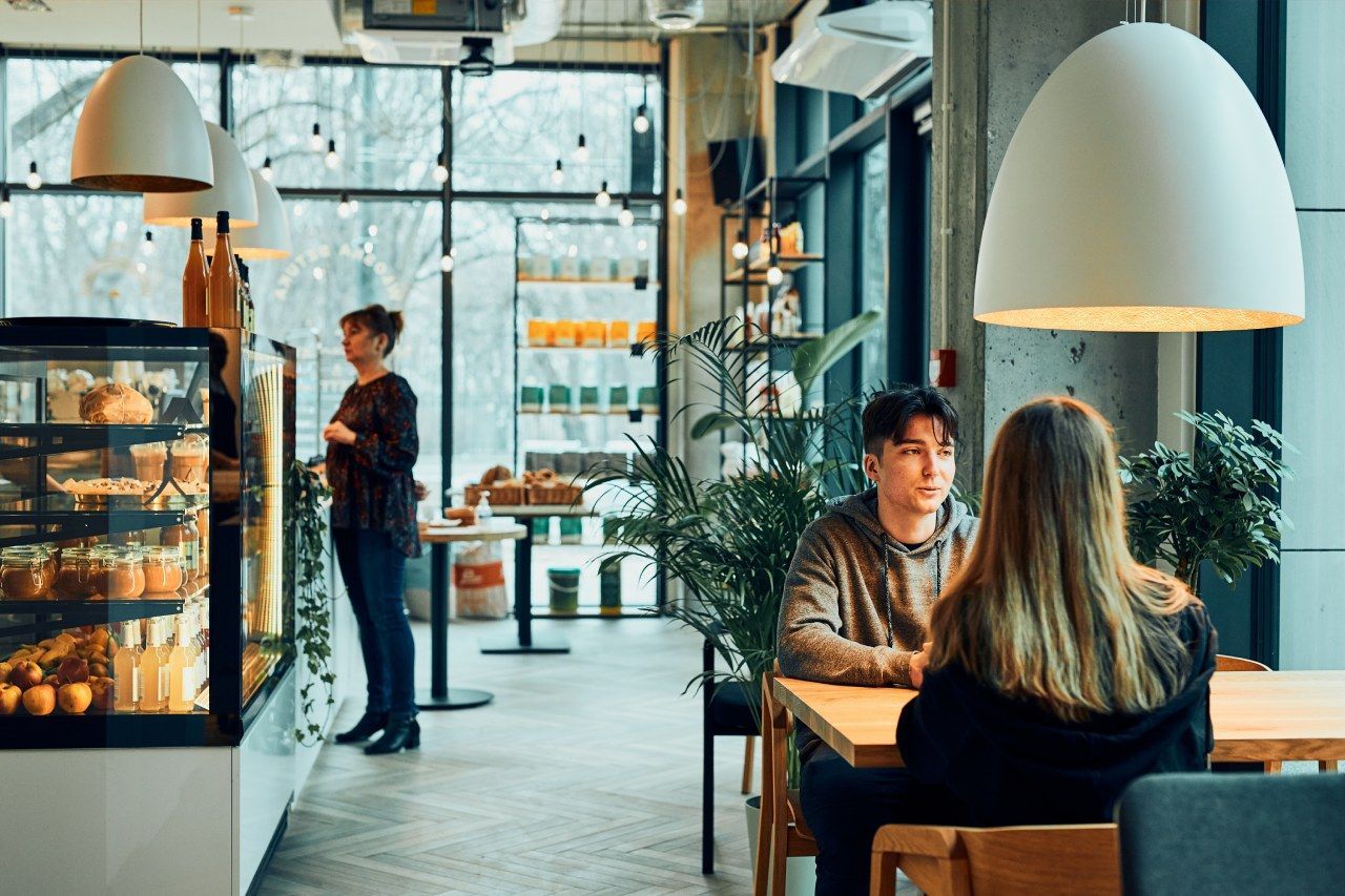 Um homem e uma mulher estão sentados à mesa em um restaurante.