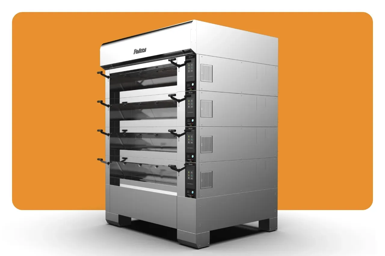 Um grande forno de aço inoxidável com rodas está sobre uma mesa.