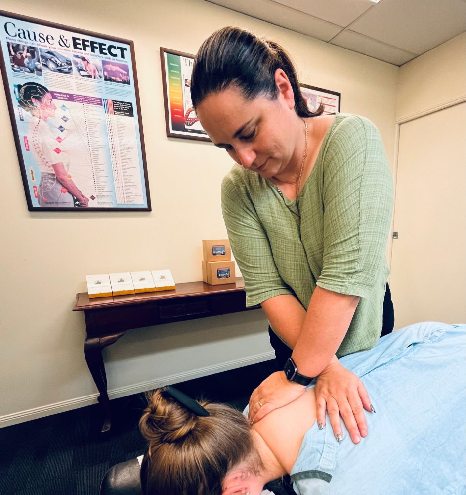 Chiropractor adjusting a patient's neck in an office— Axis Chiropractic In Cairns City, QLD