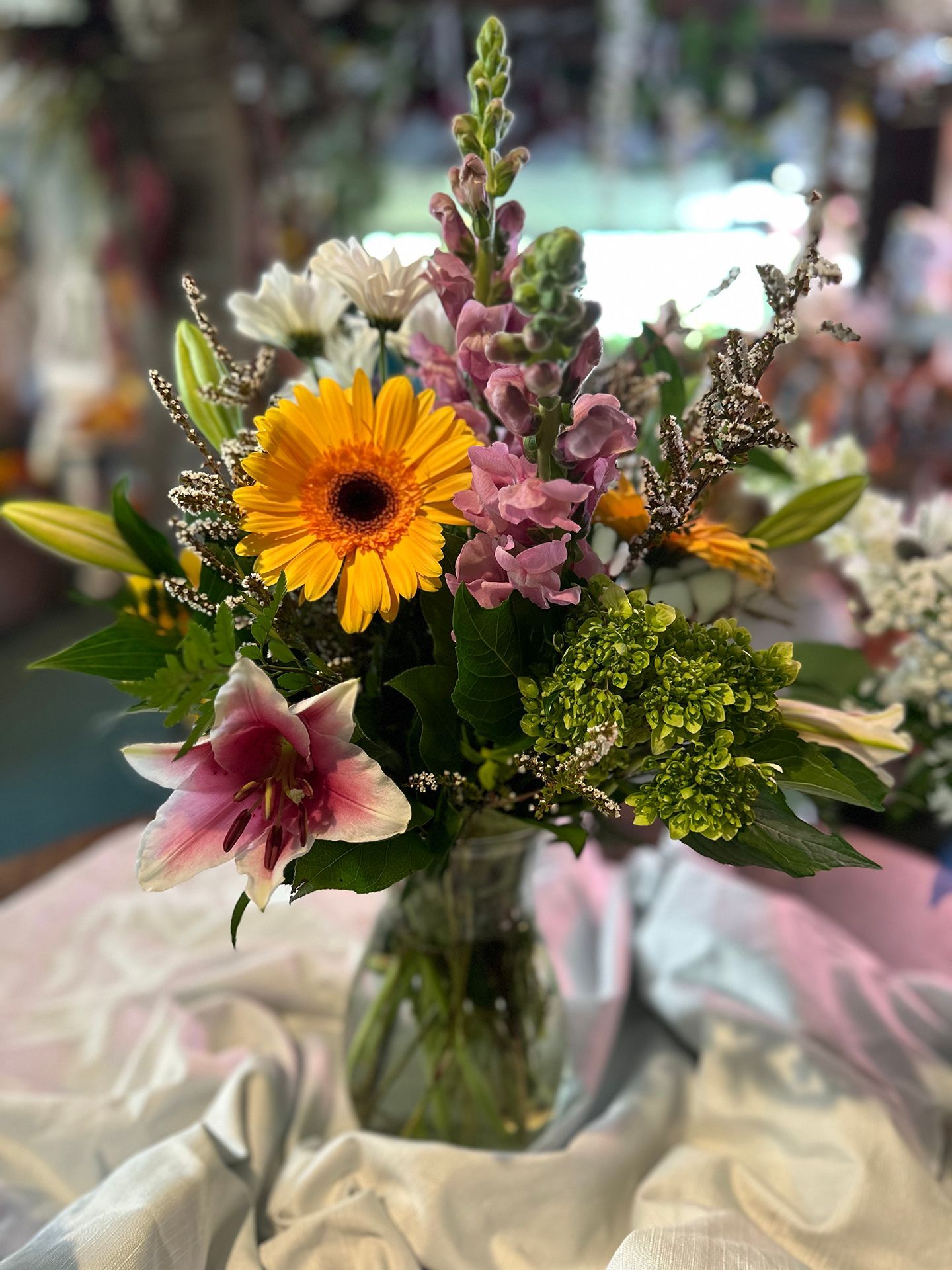 A vase filled with flowers is sitting on a table.