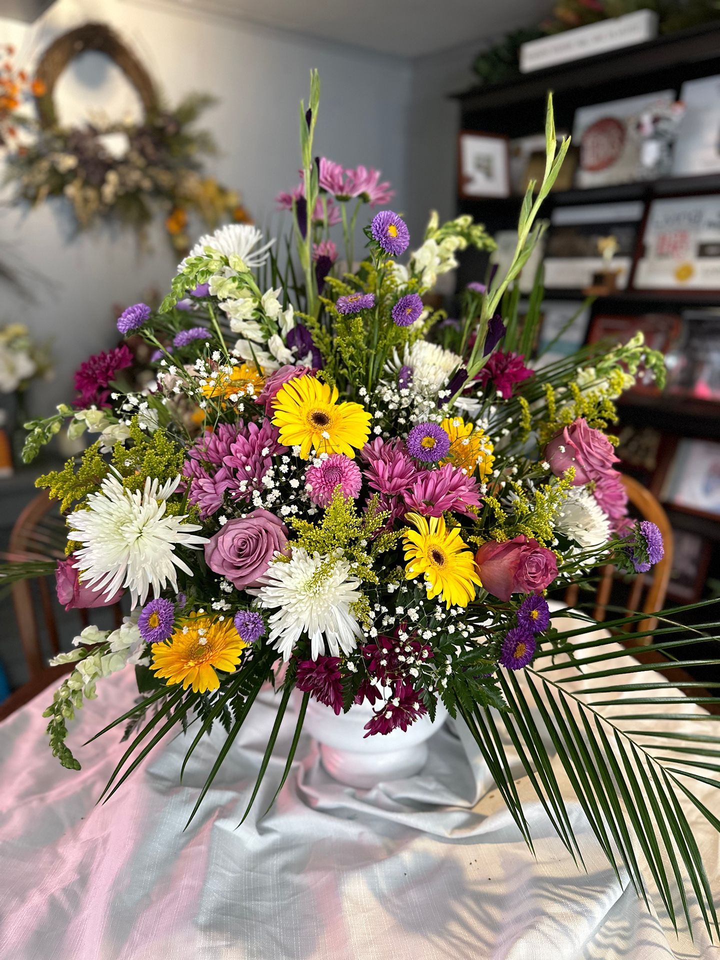 A vase filled with colorful flowers is sitting on a table.