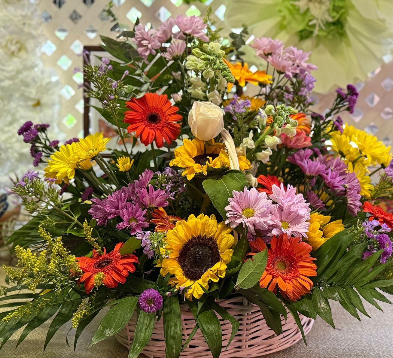basket of yellow, orange and pink flowers