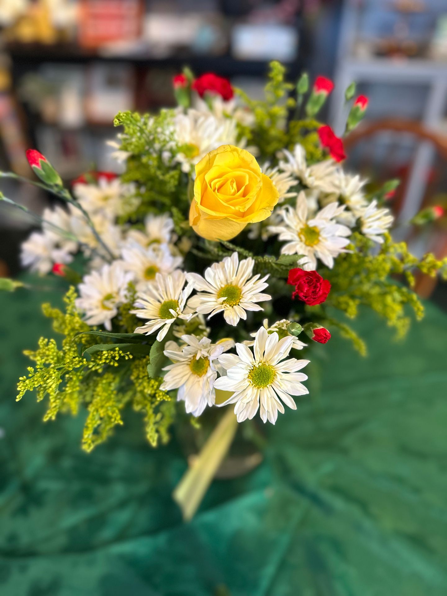 A close up of a bouquet of flowers on a table.