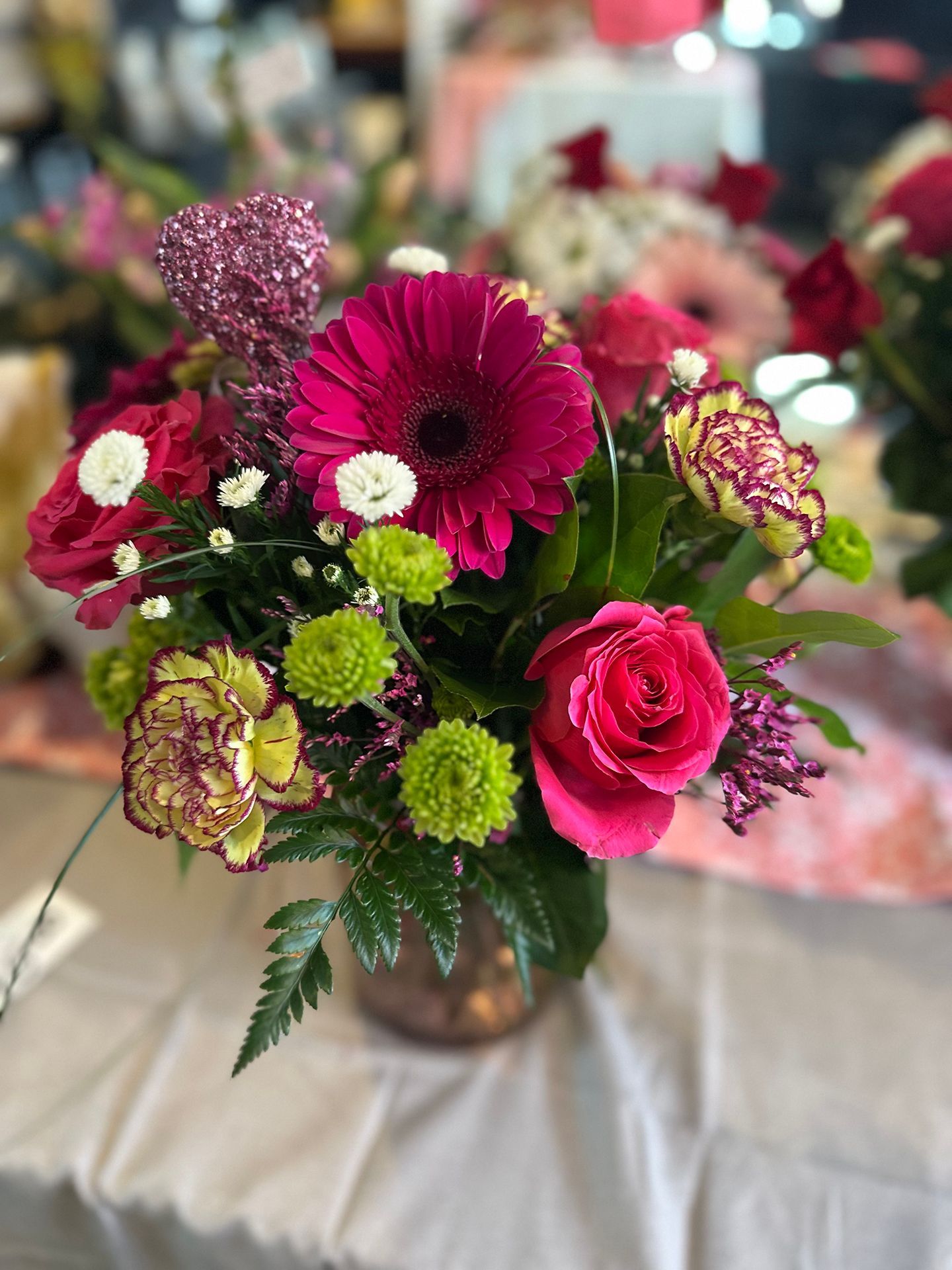 A vase filled with flowers is sitting on a table.