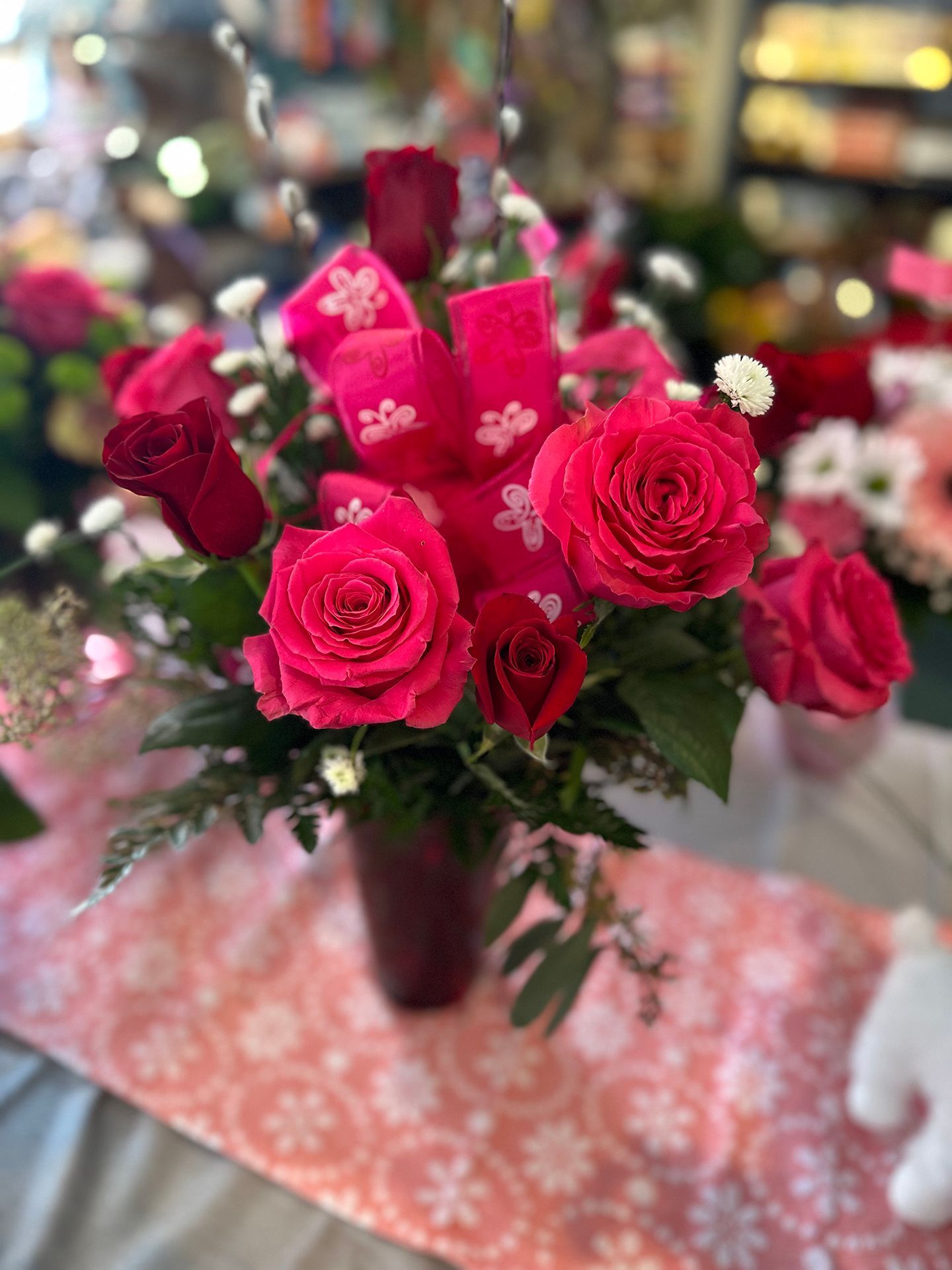 A vase filled with pink and purple flowers is sitting on a table.