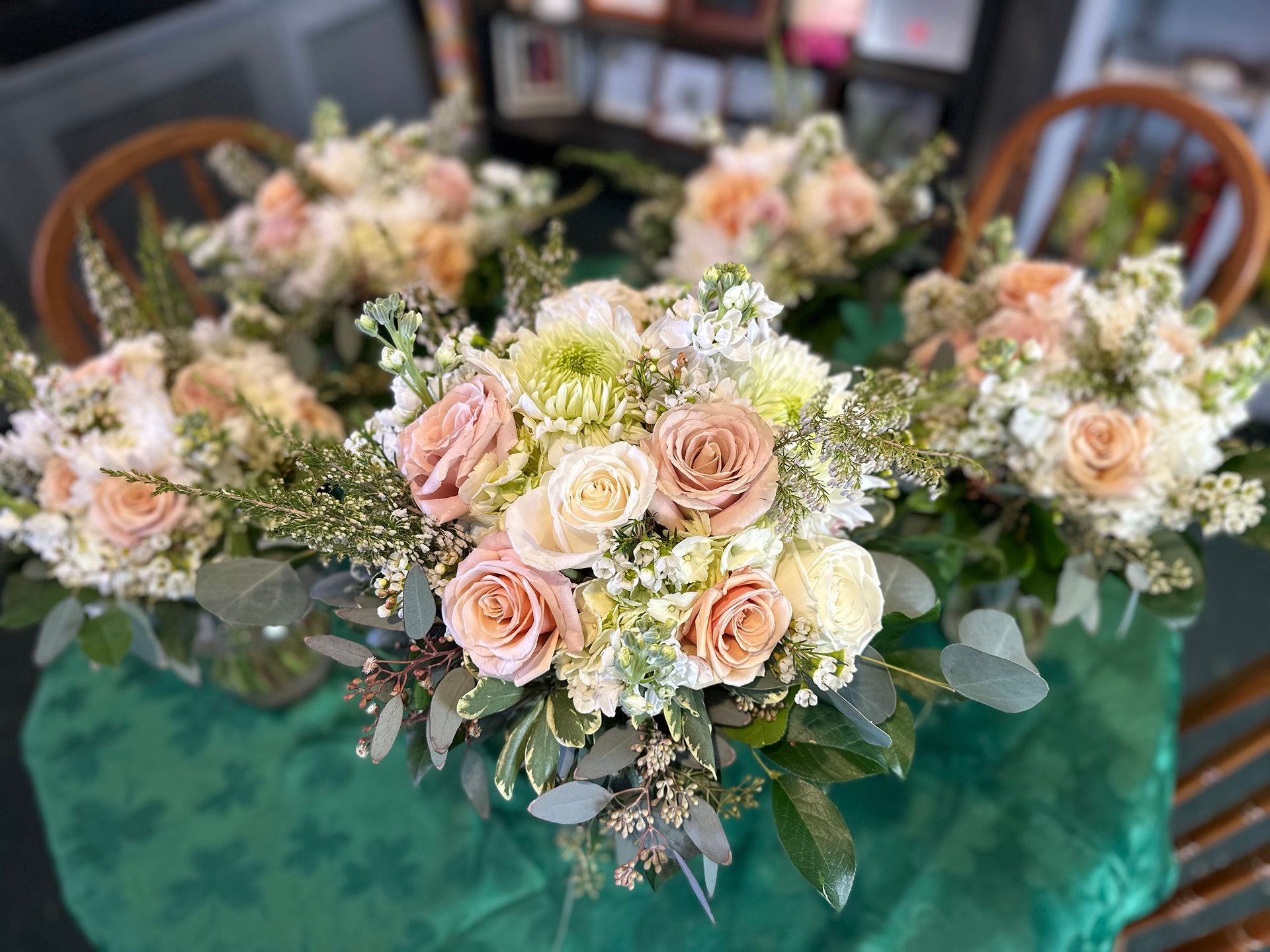 Three bouquets of flowers are sitting on a table.