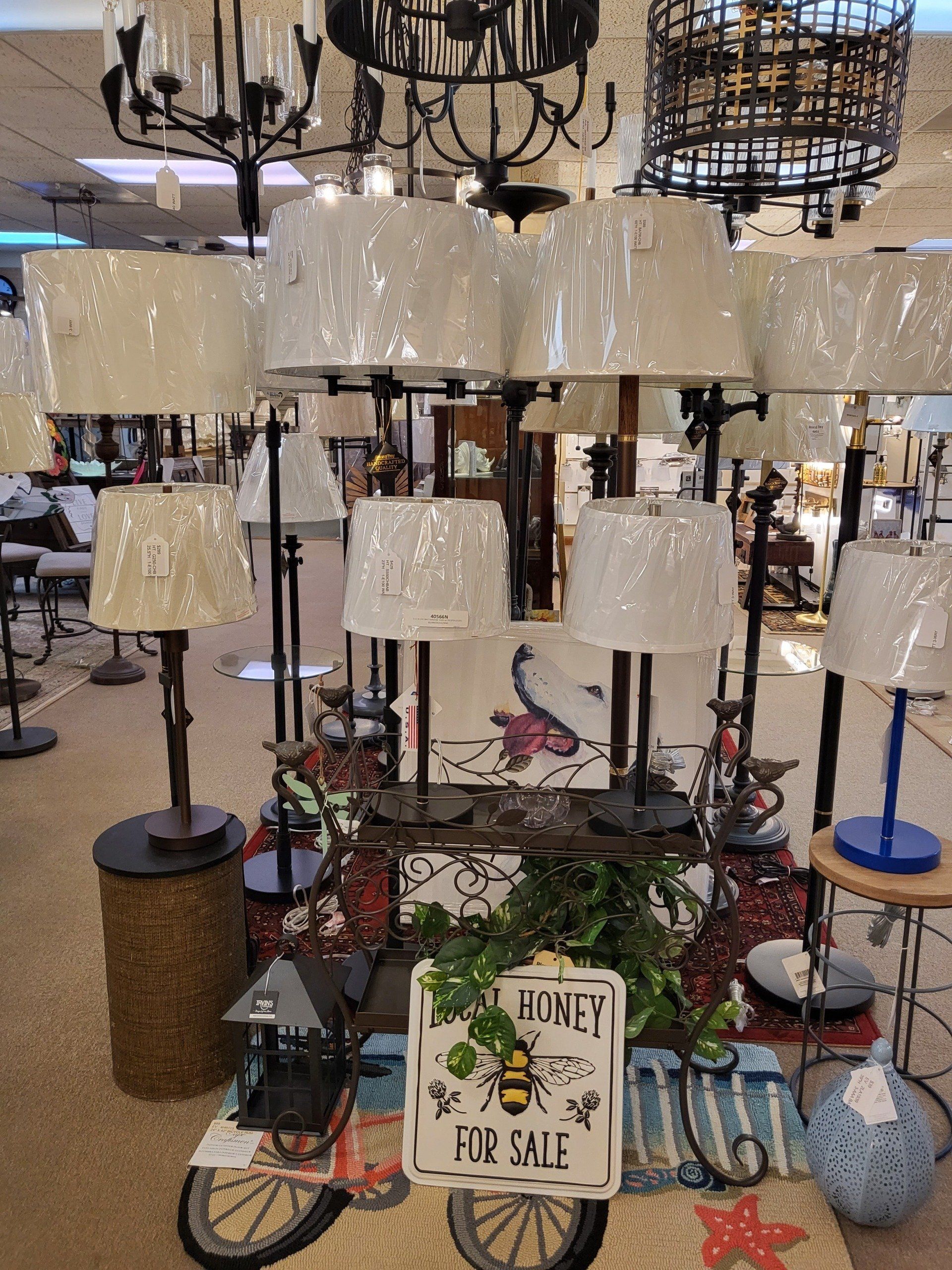 Designer floor lamps lined up in a retail lighting store in the Farmington Valley