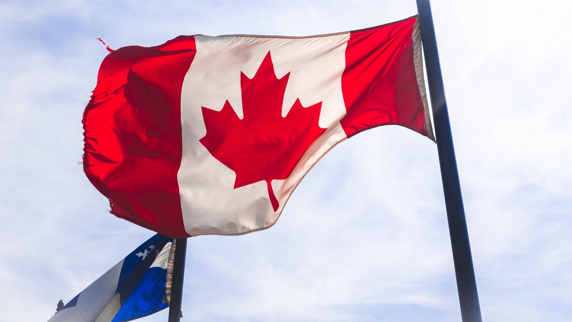 A red white and blue flag with a maple leaf on it