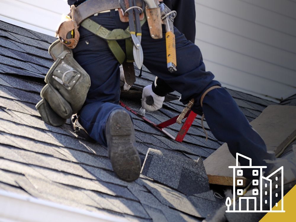 Roofer in safety gear, working on a roof with shingles, tools visible.