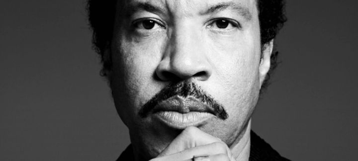 a black and white photo of a man with a mustache .
