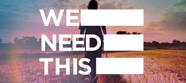 a poster that says we need this with a person walking in a field