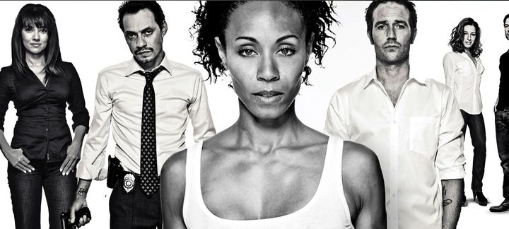 a black and white photo of a group of people standing next to each other