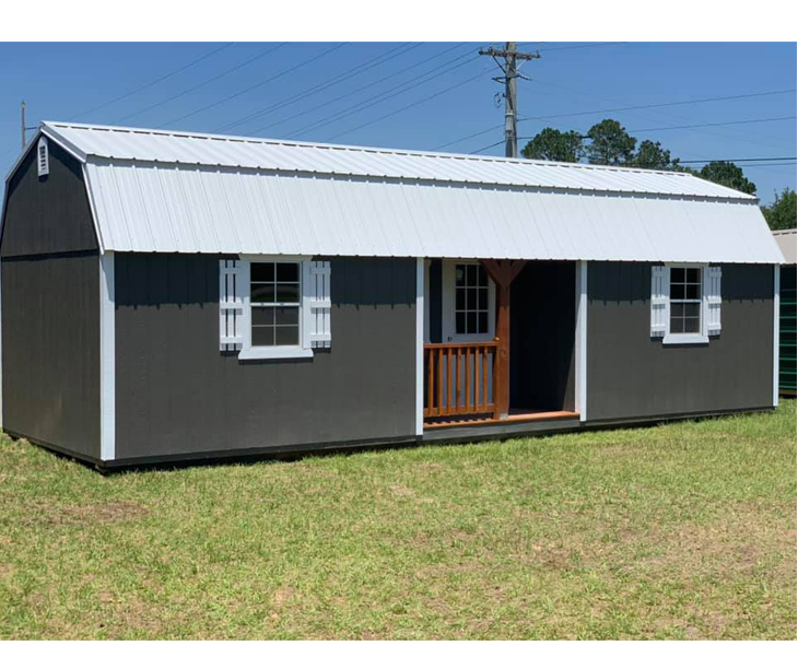 A small cabin with a white roof and shutters