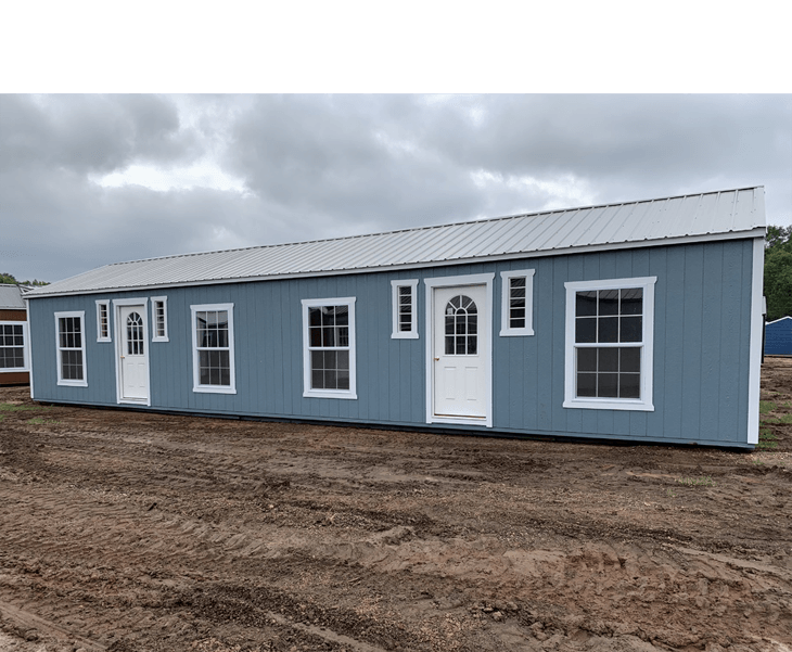 A blue shed with white doors and windows