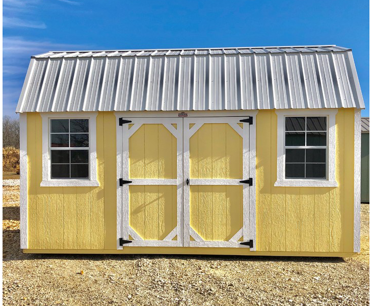 A yellow shed with a white roof and two windows