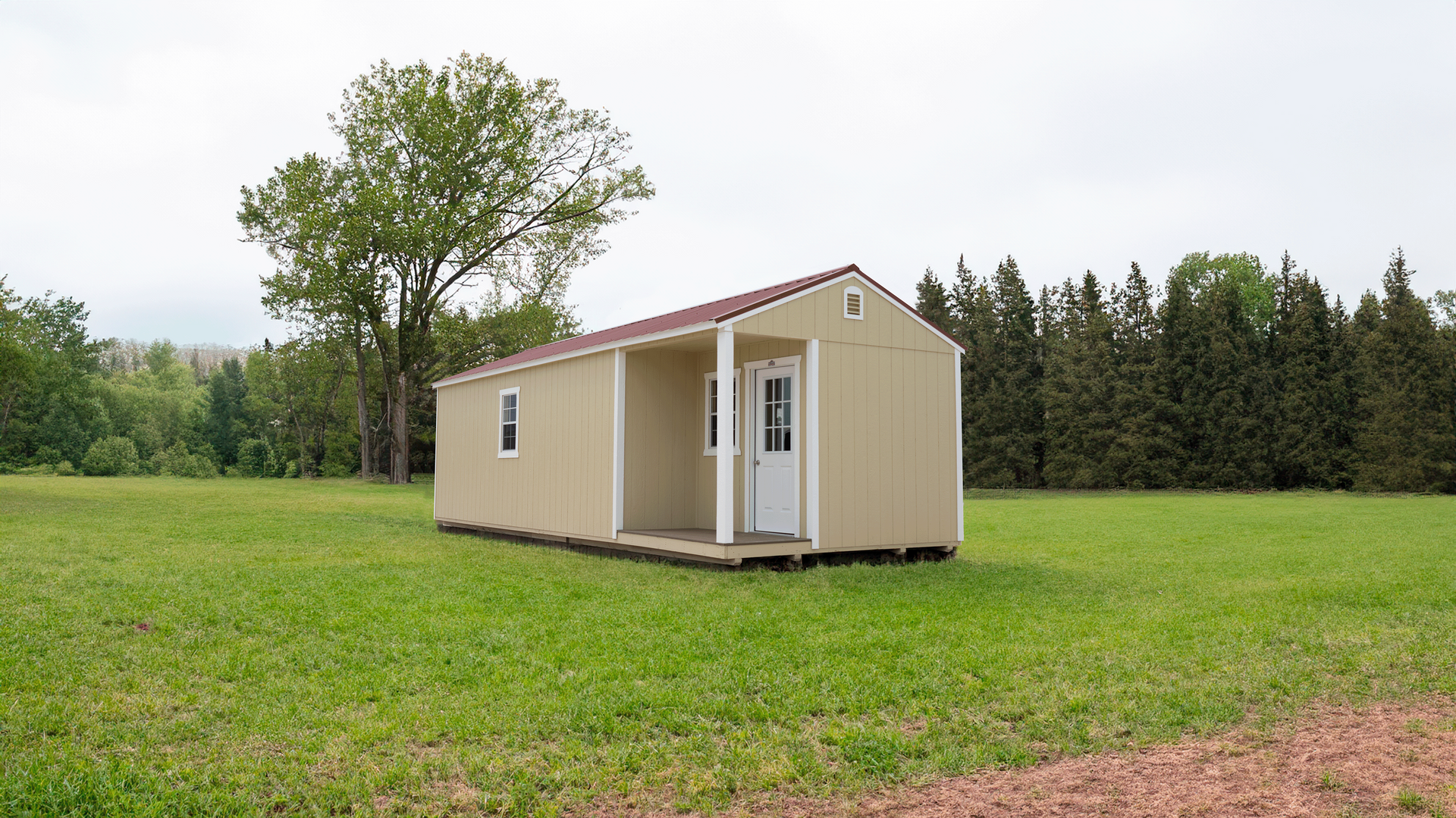 A Stor-Mor Side Cabin is sitting in the middle of a grassy field.