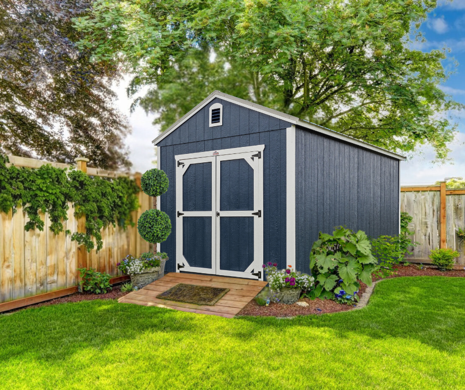 A blue and white shed in a backyard next to a wooden fence.