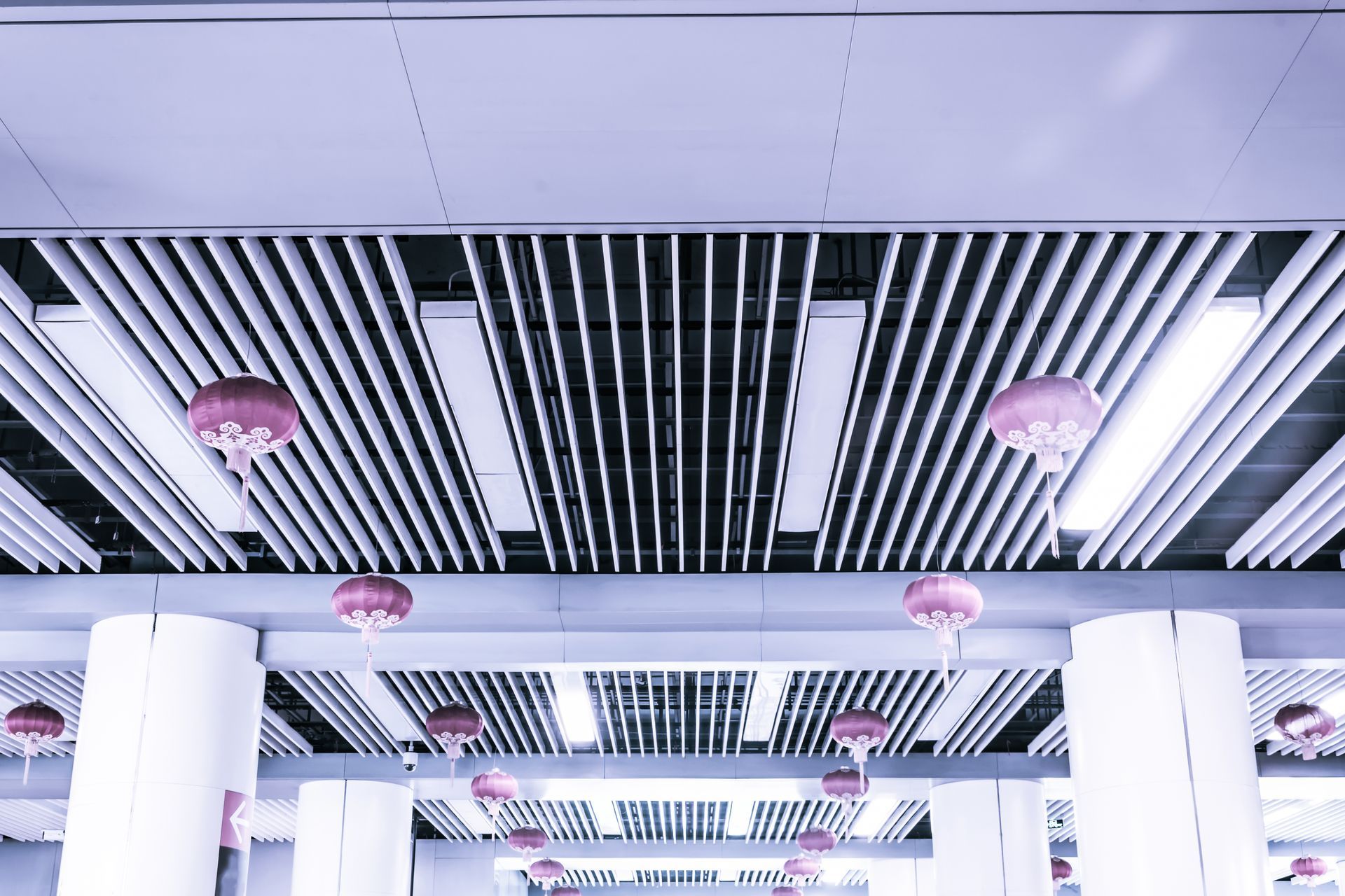 A ceiling with a lot of lights and lanterns hanging from it.