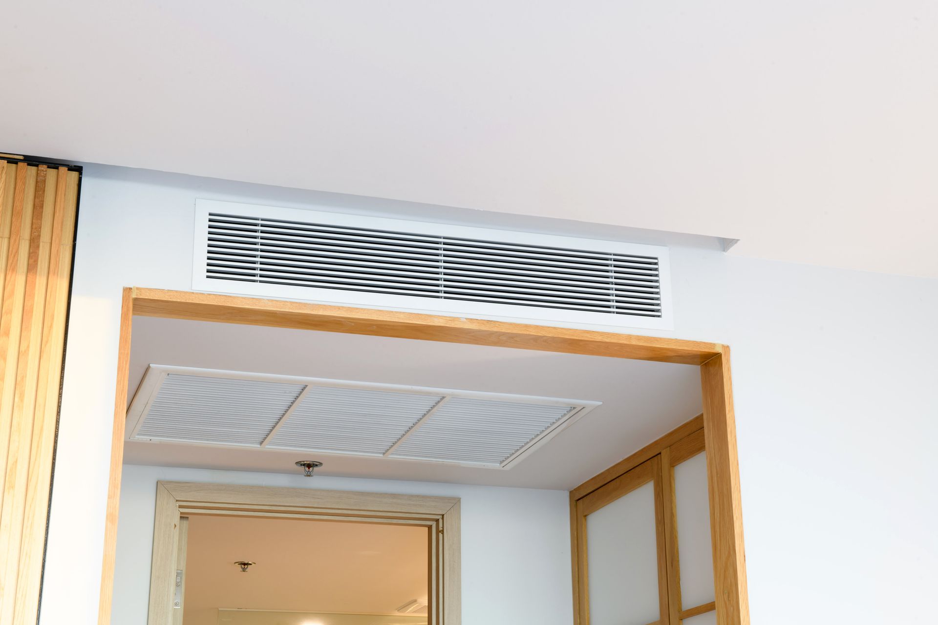 A room with a ceiling fan and a door.