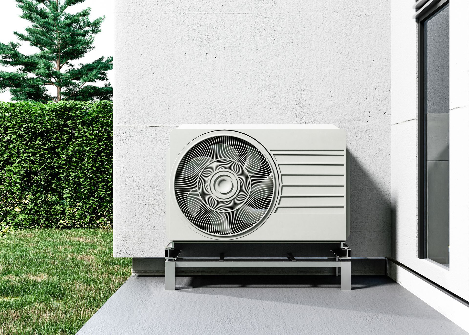 A white air conditioner is sitting on the side of a building.
