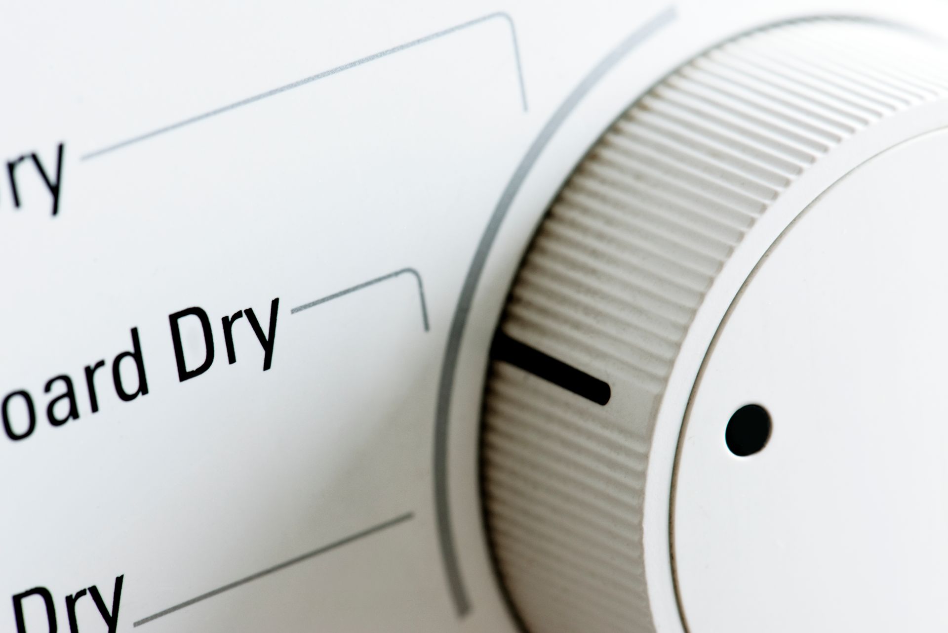 A close up of a washer and dryer knob that says board dry