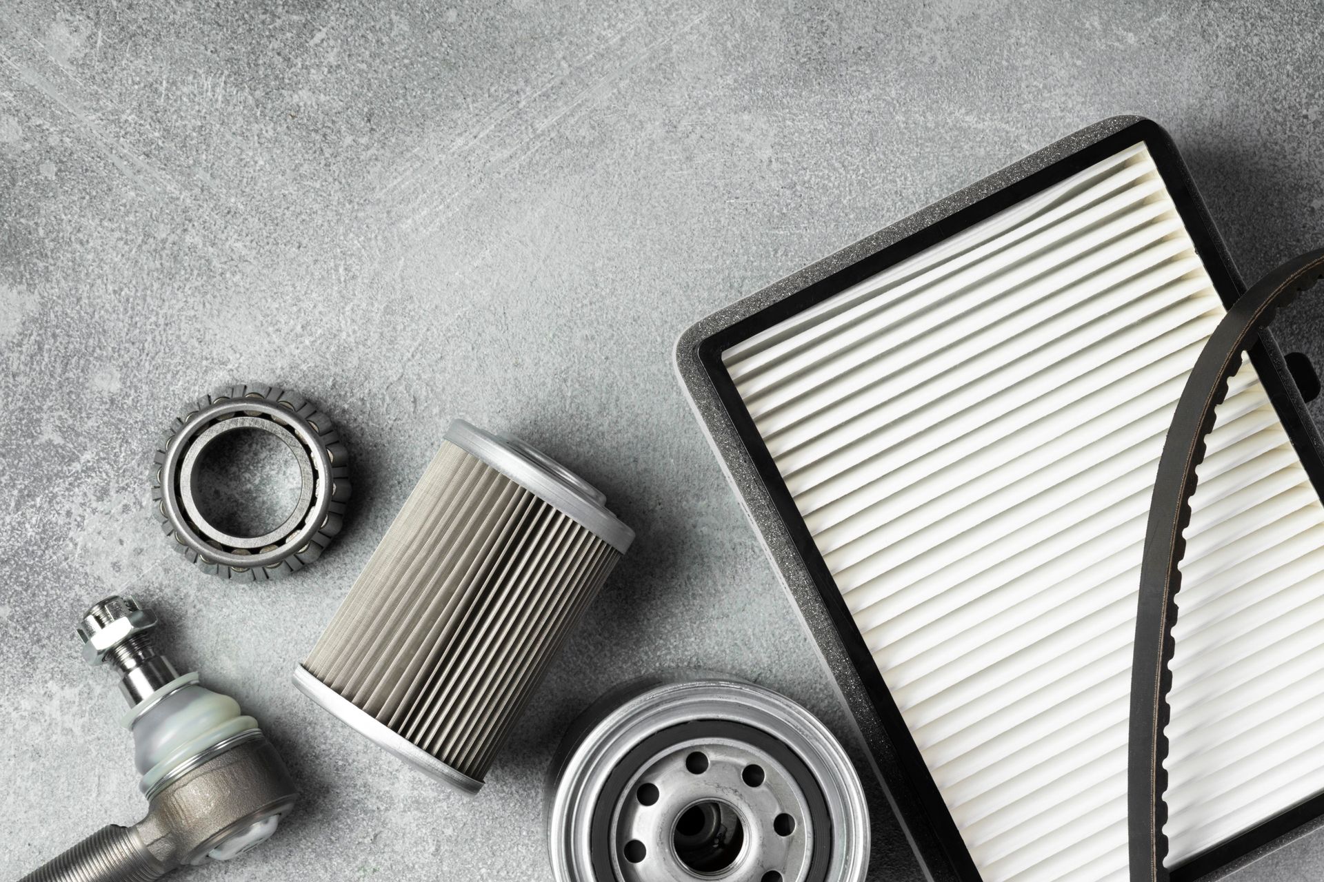 There are many different types of car parts on the table.