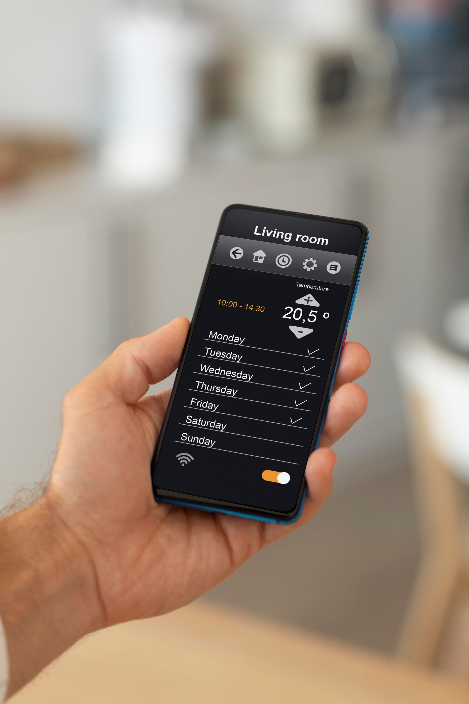 A person is holding a smart phone in their hand.