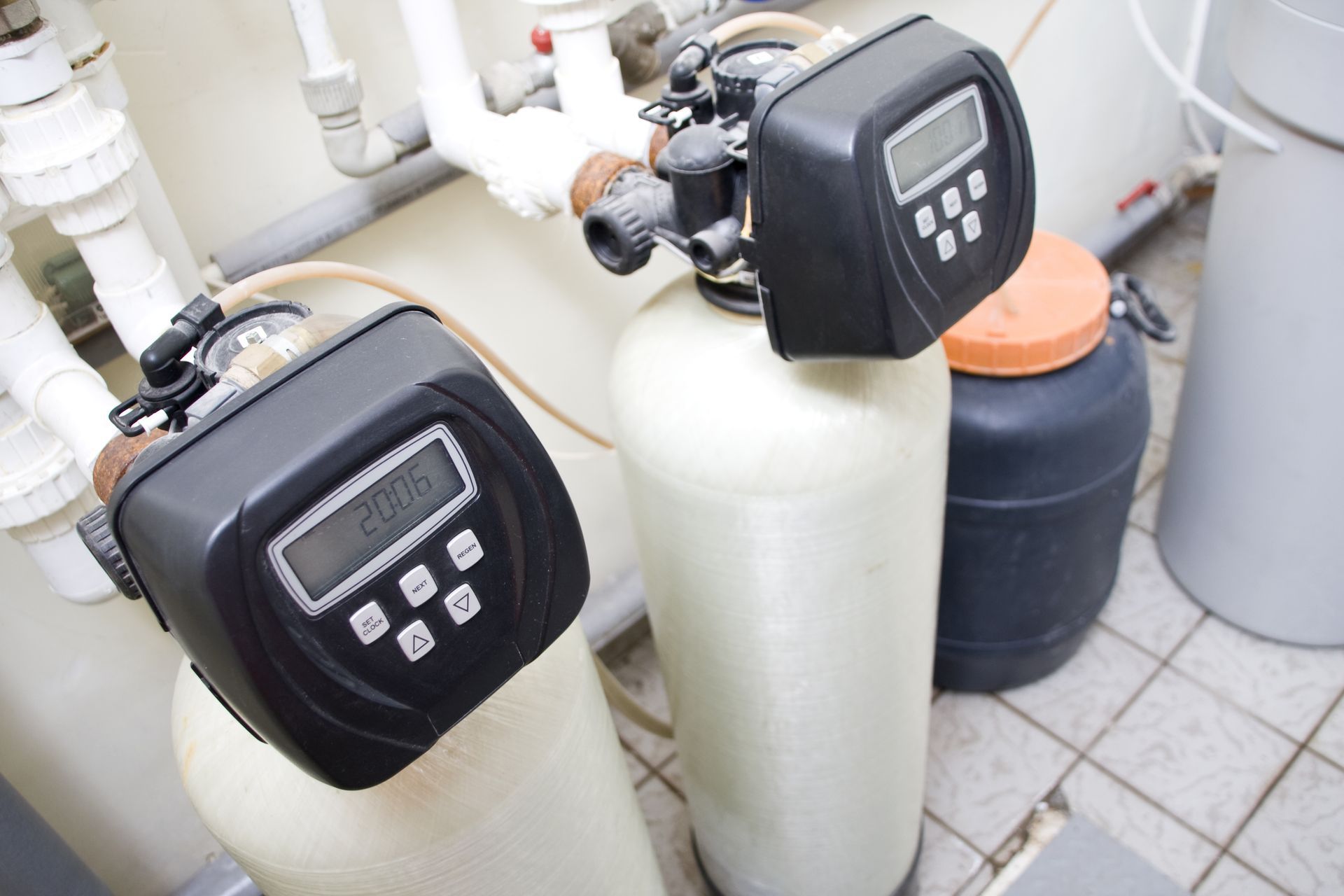 Two water filters are sitting next to each other in a room.