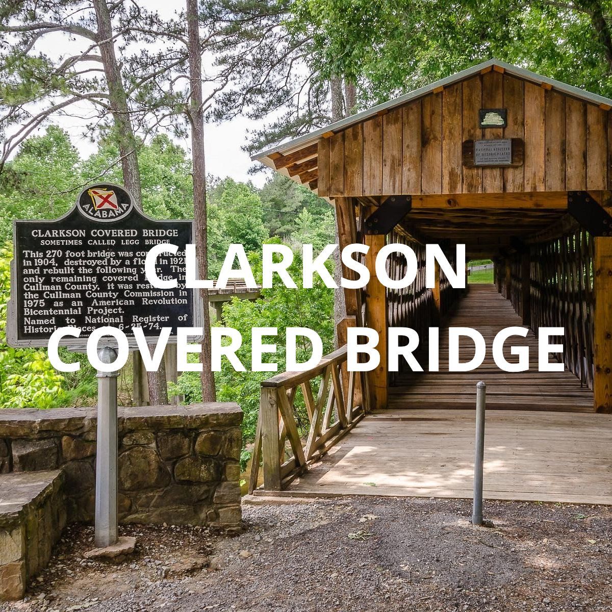 Clarkson Covered Bridge entrance with wooden bridge, black sign, and surrounding trees
