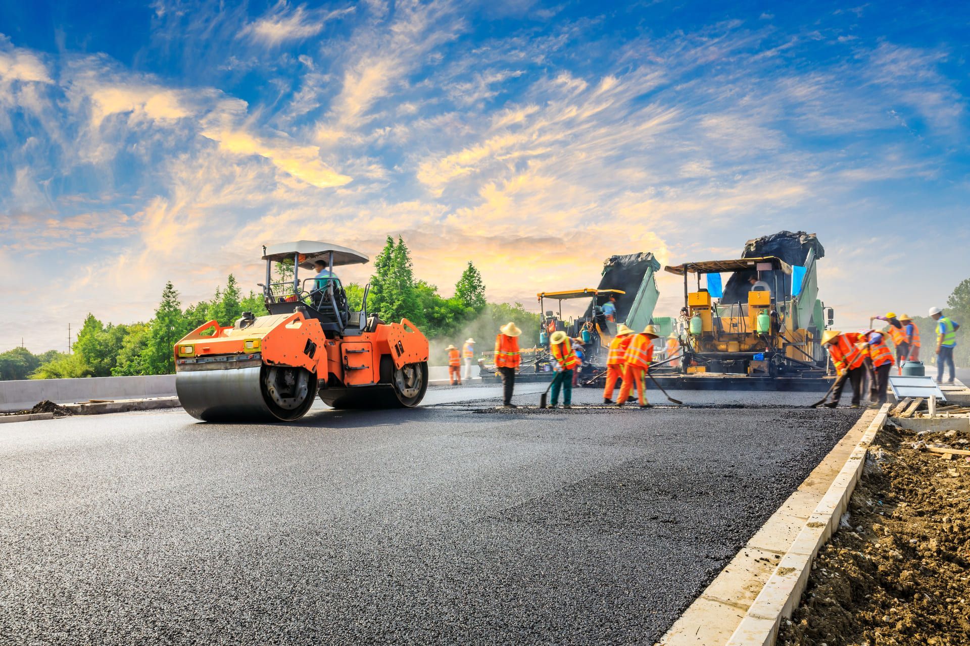 Construction site is laying new asphalt road pavement,road construction workers and road construction machinery scene.highway construction site landscape