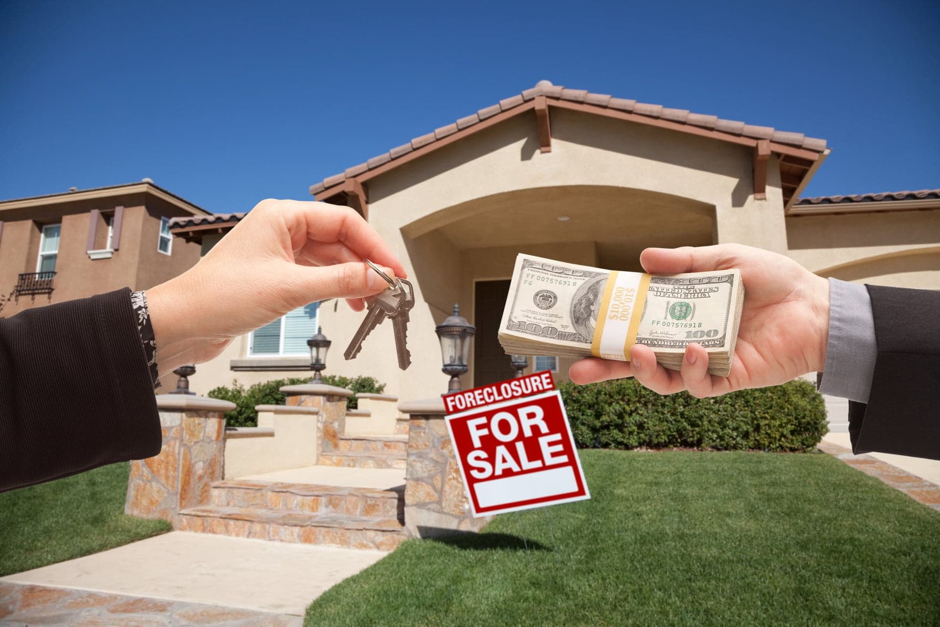 Hands exchanging house keys and cash beside a