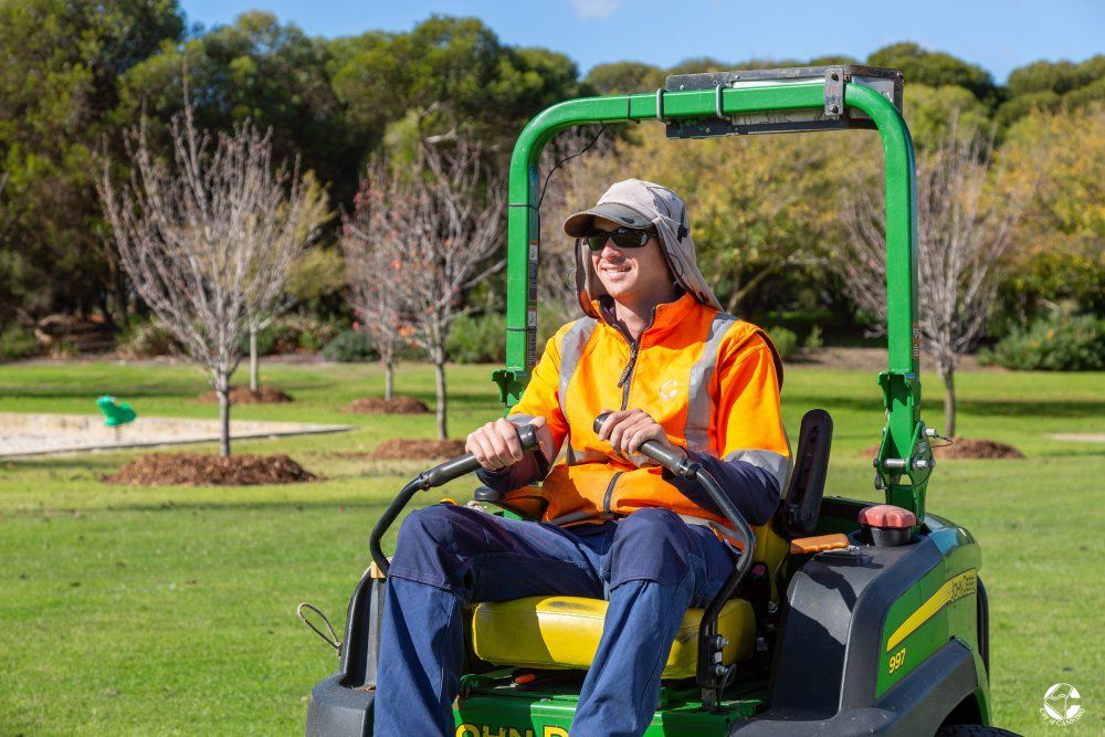 Horticulture Labourer Mowing a Garden