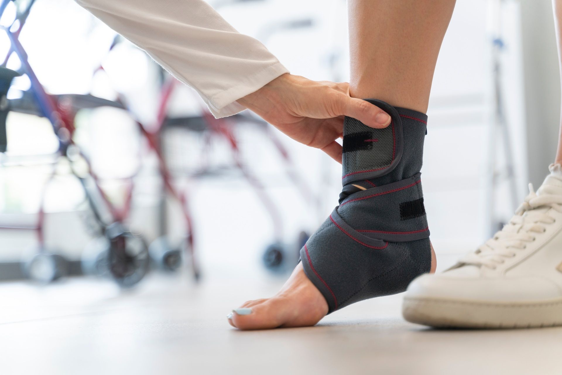 A person is wearing an ankle brace on their foot.