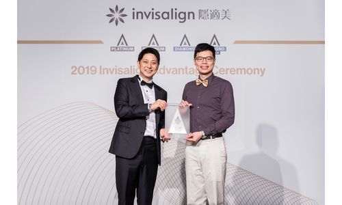 Two man holding award