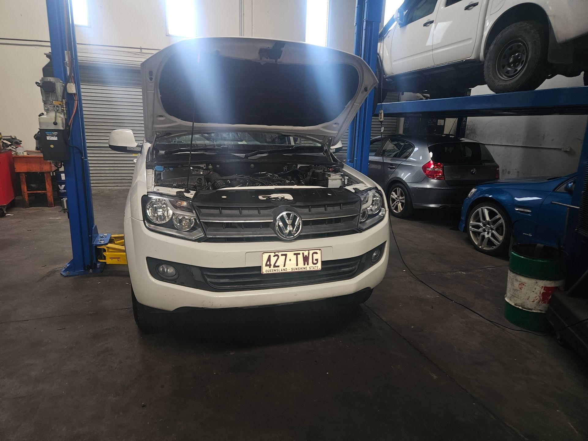 Mechanic in Blue Overalls Uses a Diagnostic Tool on a Car Engine — R&B Automotive PTY LTD In Urangan, QLD