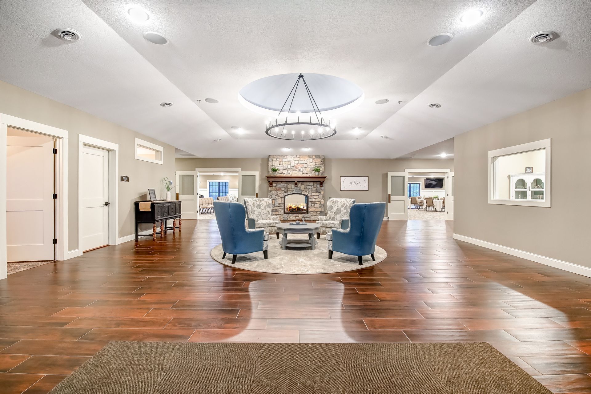 A large living room with hardwood floors and a fireplace.