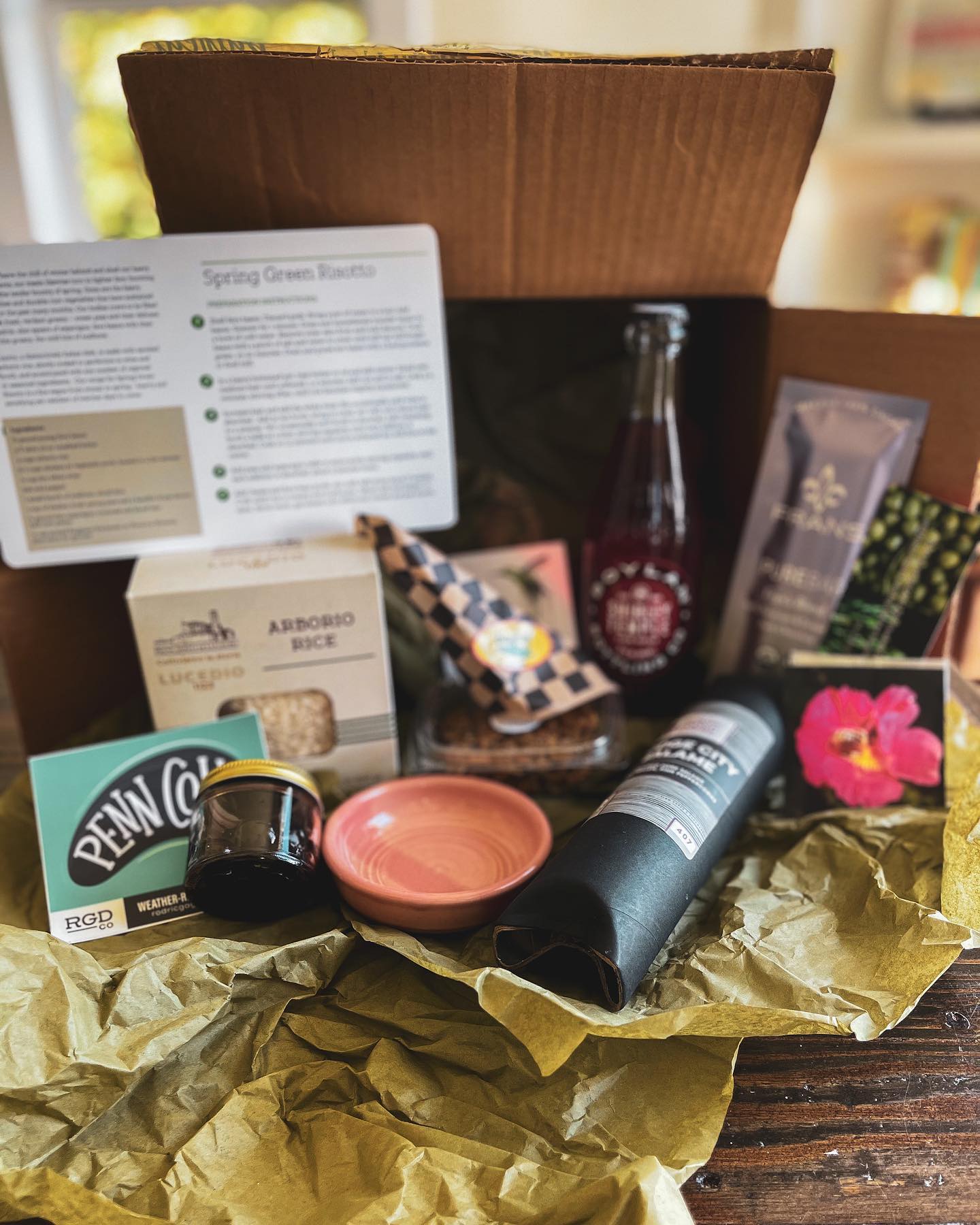 a cardboard box filled with a variety of items on a table .