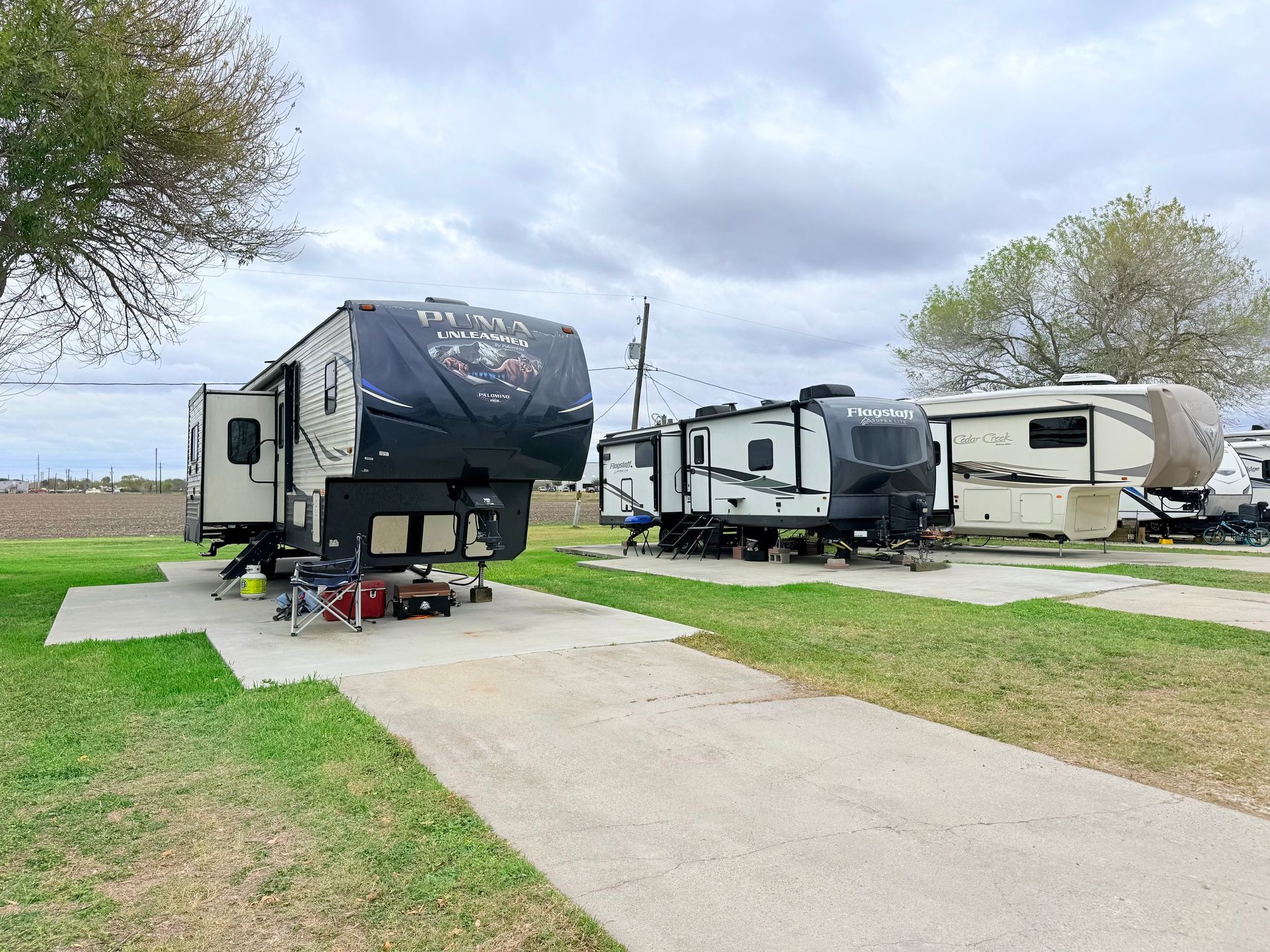 A white rv is parked under a shed.